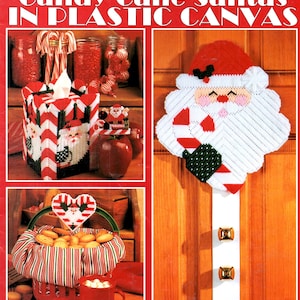 May include: A Leisure Arts craft leaflet titled Candy Cane Santas in Plastic Canvas featuring instructions for creating Santa-themed plastic canvas projects including a tissue box cover, a door hanger, a basket liner, and coasters.