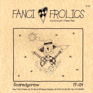 May include: A tan-colored paper with the words "FANCI FROLICS" and a heart design. The image features a scarecrow illustration with the word "Scaredycrow" and a sun and stars.