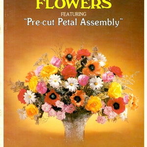 May include: A book cover featuring a colorful silk flower arrangement in a decorative vase. The text reads "SILK FLOWERS" and "Pre-cut Petal Assembly". The arrangement includes red, orange, yellow, pink, and white flowers. Instructions for 14 flowers and 18 arrangements are included.