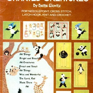 May include: A brown Leisure Arts craft leaflet titled Charted Creatures by Bette Elovitz, featuring patterns for needlepoint, cross stitch, latch hook, knit, and crochet. The cover displays various animal designs including pandas, an ostrich, and a giraffe.