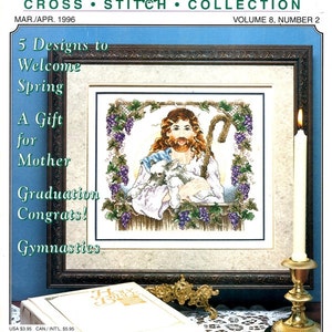 May include: A Stoney Creek Cross Stitch Collection magazine cover, Volume 8, Number 2, featuring a framed cross-stitch design titled "The Good Shepherd." The cover includes text promoting spring designs and a Bible.