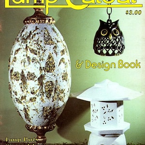 May include: A vintage book cover titled "Lamp Cutout & Design Book" featuring a large, egg-shaped lamp with gold accents and a white and gold speckled design. An owl-shaped lamp and a white pagoda-style lamp are also shown.