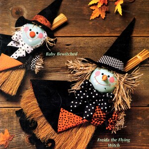 May include: A McCall's Creates magazine cover featuring two handmade witch dolls. The dolls have straw hair, black hats, and are dressed in black and orange. The text reads "Best Witches", "Baby Bewitched", and "Freida the Flying Witch".