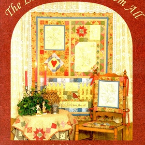 May include: A book cover with the text "The Lord God Made Them All" in a decorative font. The cover features a quilt with floral designs, a small table with a quilt, candles, and a decorative chair. The book is part of the "Blessings Quilt Series".