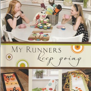 May include: A Disa Designs instructional book titled My Runners Keep Going, featuring a cover with a photograph of two people at a table with table runners, and three smaller images showing various table runner designs with seasonal motifs.