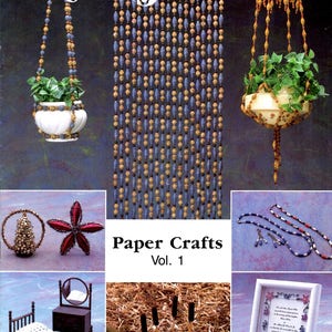 May include: The Craft Beader magazine cover featuring various paper crafts. Includes beaded hanging planters, a beaded curtain, a star-shaped ornament, a miniature bed, and a framed poem. The text "Paper Crafts Vol. 1" is also visible.