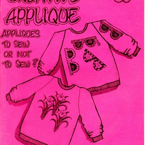 May include: A pink book cover titled "CREATIVE APPLIQUE" with illustrations of two sweatshirts. One sweatshirt has sunglasses appliqued on it, and the other has flower appliqués. The text "APPLIQUES TO SEW OR NOT TO SEW?" is also on the cover. The author is Marlene Coleman.