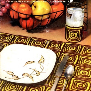 May include: A vintage magazine cover titled "Table Magic" featuring a crochet placemat, glass jacket, and bottle cap crochet. A white plate with a leaf design, a knife, and a spoon are on the placemat. A glass with a crochet coaster and a fruit basket are also visible.