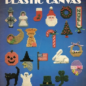 May include: A collection of 23 holiday-themed plastic canvas magnet designs. Includes a Santa, Christmas tree, witch, pumpkin, and American flag. The cover reads "Holiday Magnets for Plastic Canvas."