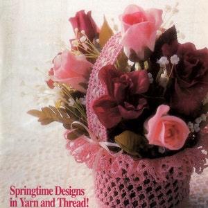 May include: The cover of Annie's Crochet Newsletter features a pink crocheted basket filled with pink and burgundy roses. The text "Springtime Designs in Yarn and Thread!" is visible. The magazine's title is in pink.