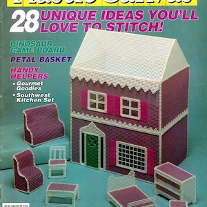 May include: A craft magazine titled Quick & Easy Plastic Canvas No. 29 featuring a two-story dollhouse and miniature furniture made from plastic canvas. The cover displays a purple house with a white roof, a green door, and pink shutters.