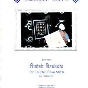 May include: A white brochure titled "Homespun Hearts" with the text "Amish Baskets for Counted Cross Stitch and Needlepoint." The brochure features a framed cross-stitch design and a figure holding a cross-stitch project.