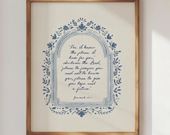 May include: Framed print featuring a quote from Jeremiah 29:11 in blue script. The quote is surrounded by a blue floral border on a cream-colored background. The frame is made of wood.