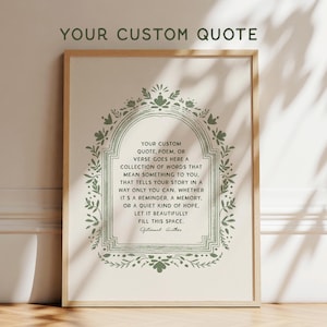 May include: A framed print with the text "YOUR CUSTOM QUOTE" at the top. The print features a decorative green border and a central text area with a quote about personal stories and memories. The frame is a light wood color.