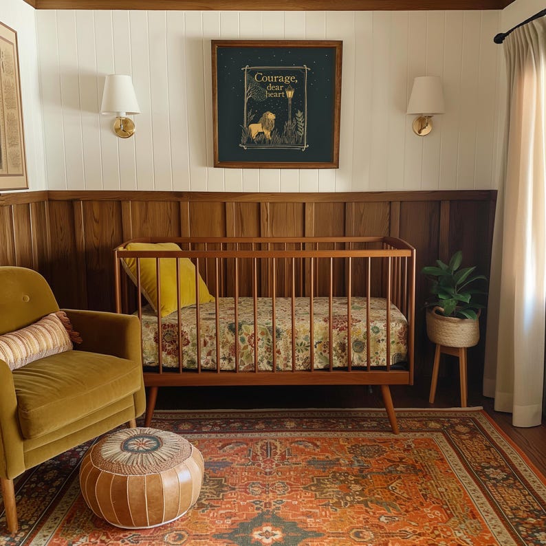 May include: A mid-century modern nursery with a wooden crib, a mustard-colored armchair, and a patterned rug. A framed print with the text "Courage, dear heart" hangs above the crib. A small plant in a woven pot sits on a wooden stand.