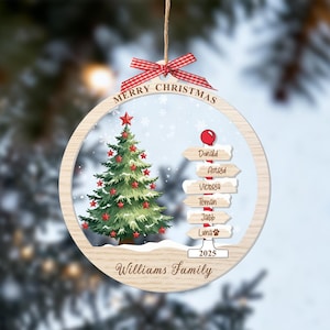 May include: A round wooden Christmas ornament featuring a green tree with red stars, a signpost with the names Donald, Astrid, Victoria, Teman, Jacob, and Luna, the text Merry Christmas, 2025, and Williams Family, topped with a red gingham bow.