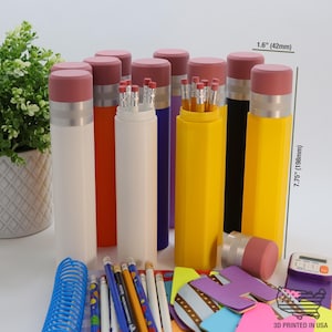 May include: Assortment of 10 colorful pencil holders shaped like pencils. Each holder is 7.75 inches tall and 1.6 inches wide. The holders are made of plastic and have a red eraser on top. The holders are filled with pencils. 3D Printed in USA.