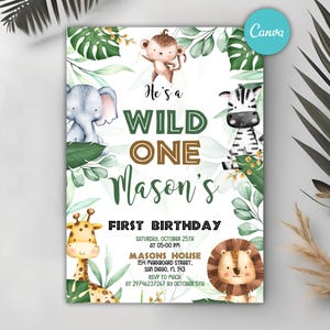 May include: A green, white, and brown invitation for a first birthday party. The invitation features a jungle theme with a monkey, elephant, zebra, giraffe, and lion. The text on the invitation reads "He's a Wild One Mason's First Birthday".