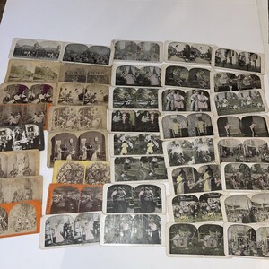 May include: A collection of vintage stereoscopic cards, featuring various scenes and images. The cards are arranged in rows, showcasing a variety of historical photographs. The cards have a sepia tone, with some featuring hand-painted color details. The collection includes images of people, landscapes, and events.