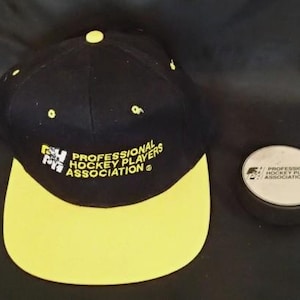 A Vintage Professional Hockey Players Association Unworn Snapback Cap and Puck