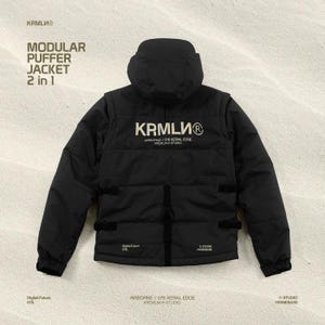 May include: A black modular puffer jacket with a hood, featuring the text "KRMLU" and "MODULAR PUFFER JACKET 2 in 1". The jacket has multiple pockets and straps. Additional text includes "Digital Future 078", "AIRBORNE // 078 AERIAL EDGE KREMLIN STUDIO", and "STUDIO HOMEBASE".