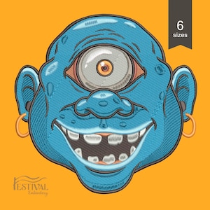 May include: A blue cyclops face with a large eye, a wide grin, and gold hoop earrings. The image has a textured, embroidered appearance. The background is orange, and a black banner indicates "6 sizes". The logo "Festival Embroidery" is at the bottom.