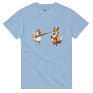 Funny hen T shirt with cartoon hen holding a gun pointed towards a fox! Perfect for any hen keeper recruiting a hunter for Mr Fox.