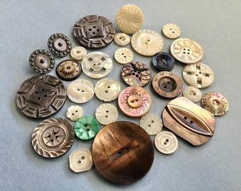 Lot of 28 vintage and antique carved mother of pearl buttons 3/8 to 1 1/2”.