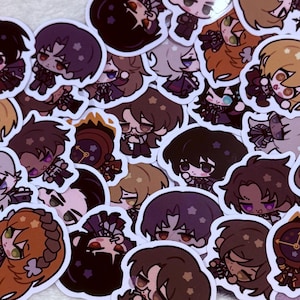 May include: A collection of colorful cartoon character stickers featuring various designs and expressions. The stickers are printed on white paper and have a glossy finish.