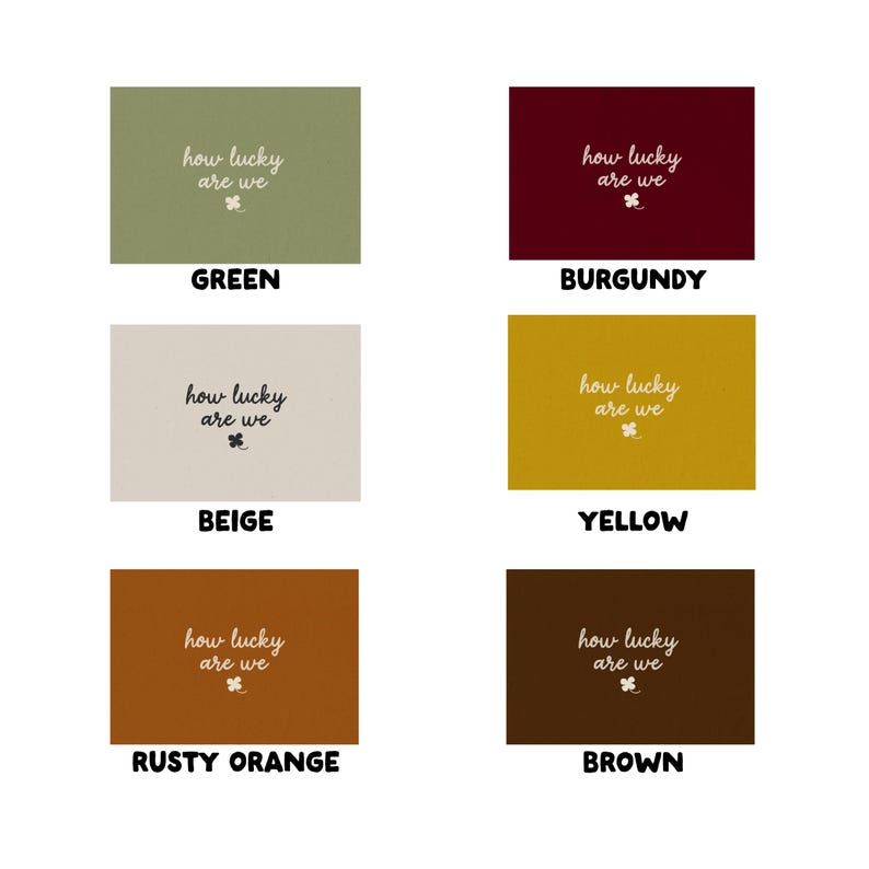 May include: A collection of six rectangular cards in various colors: green, burgundy, beige, yellow, rusty orange, and brown. Each card features the phrase "how lucky are we" in a handwritten style, along with a small clover graphic.
