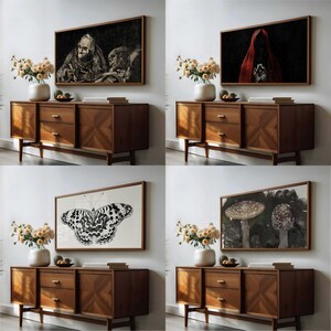 4 Halloween art frame TV images mocked up in an art TV in a living room on the wall above a sideboard with dried flowers and books on.