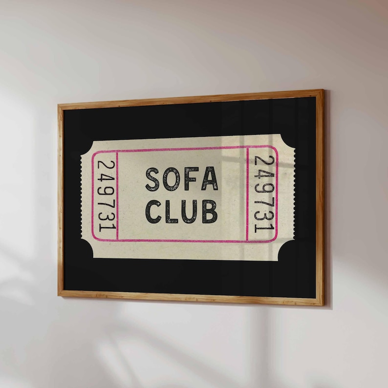 May include: A framed print featuring a vintage-style ticket design. The ticket has the words "SOFA CLUB" in a bold font, with the number "249731" on each side. The frame is a natural wood color.