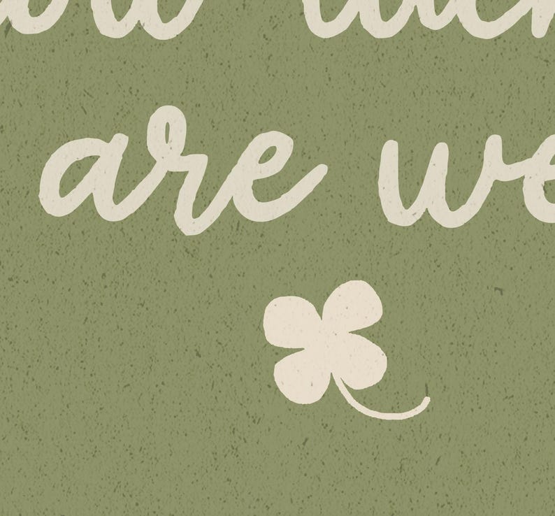 May include: A textured, olive green background with the words "how much are we" in a cream-colored, cursive font. A cream-colored four-leaf clover is at the bottom. The image has a vintage, rustic feel.