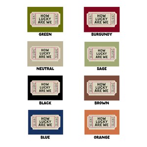 May include: A collection of eight rectangular tickets in various colors, each with the text "HOW LUCKY ARE WE" and the number "249731". Colors include green, burgundy, neutral, sage, black, brown, blue, and orange.