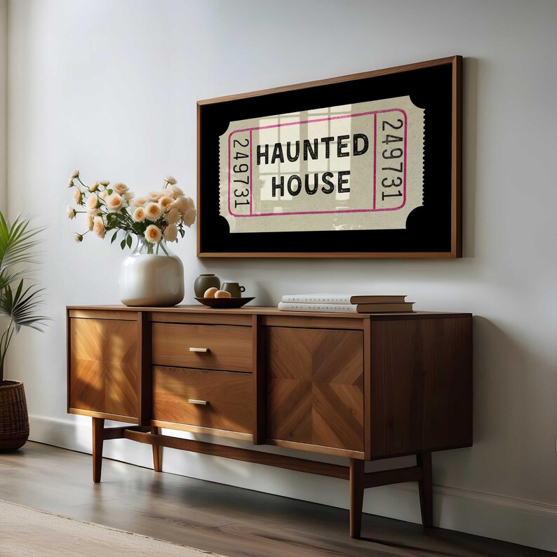 Halloween TV art featuring a cream vintage ticket stub on a black background. Inside the ticket it says HAUNTED HOUSE in black font. 16:9 ratio for Samsung art TV.