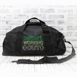 May include: Black duffel bag with a green, yellow, and white embroidered design that says "Darian's Working Out" with a dumbbell graphic.