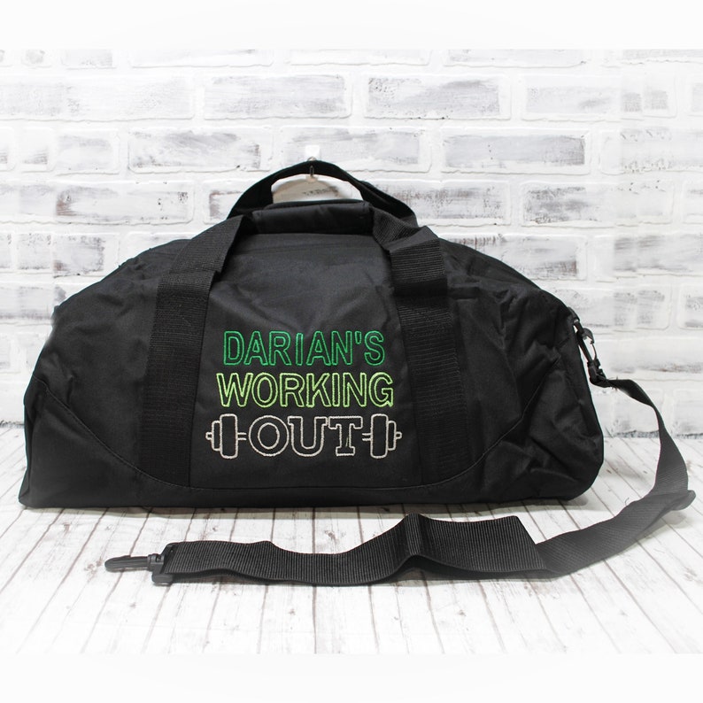 May include: Black duffel bag with a green, yellow, and white embroidered design that says "Darian's Working Out" with a dumbbell graphic.