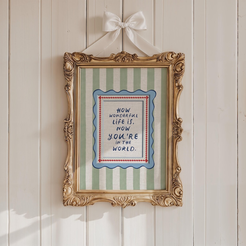 A timeless How Wonderful Life Is Now You’re In the World nursery print in soft sage green tones with classic stripes and a vintage circus feel. Perfect for playroom wall art, kids wall art, and baby room wall decor. This heartfelt nursery quote print adds warmth and meaning to any space, pairing beautifully with sage green nursery art and traditional circus nursery themes. Ideal for parents who love vintage playroom art and storybook-inspired design.