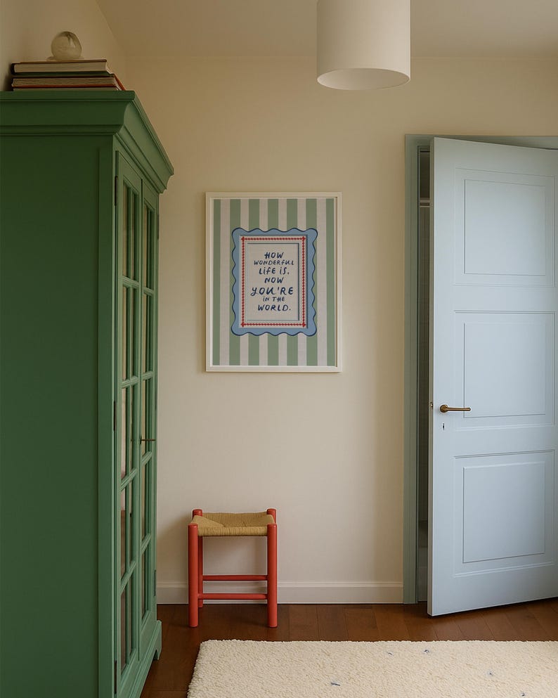 A timeless How Wonderful Life Is Now You’re In the World nursery print in soft sage green tones with classic stripes and a vintage circus feel. Perfect for playroom wall art, kids wall art, and baby room wall decor. This heartfelt nursery quote print adds warmth and meaning to any space, pairing beautifully with sage green nursery art and traditional circus nursery themes. Ideal for parents who love vintage playroom art and storybook-inspired design.