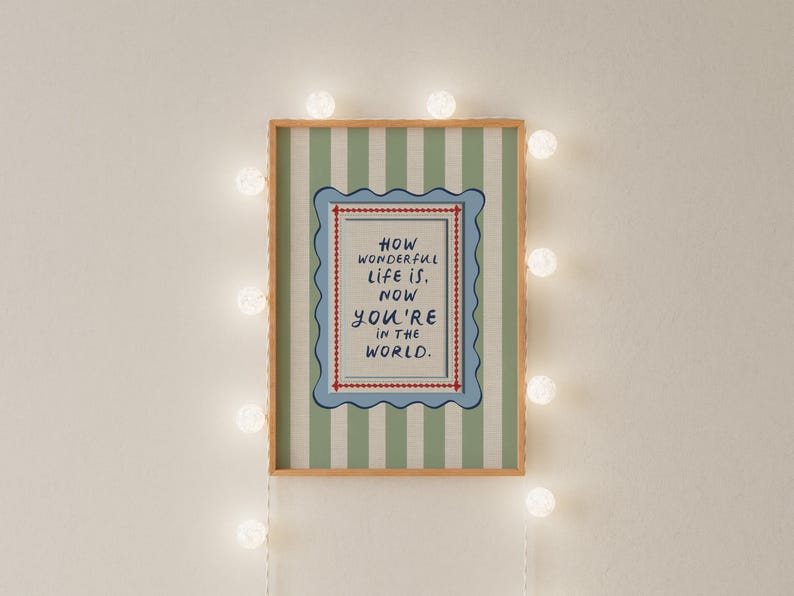 A vintage-inspired How Wonderful Life Is Now You’re In the World nursery print designed in soft sage green with playful stripes and a wavy frame. Perfect as kids wall art, playroom wall art, or part of a whimsical circus nursery theme. This timeless design brings warmth and storybook charm to baby rooms and makes a thoughtful gift for new parents. A beautiful piece of sage green nursery art for classic, character-filled interiors.