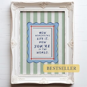 A timeless How Wonderful Life Is Now You’re In the World nursery print in soft sage green tones with classic stripes and a vintage circus feel. Perfect for playroom wall art, kids wall art, and baby room wall decor. This heartfelt nursery quote print adds warmth and meaning to any space, pairing beautifully with sage green nursery art and traditional circus nursery themes. Ideal for parents who love vintage playroom art and storybook-inspired design.