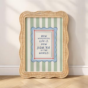 A timeless How Wonderful Life Is Now You’re In the World nursery print in soft sage green tones with classic stripes and a vintage circus feel. Perfect for playroom wall art, kids wall art, and baby room wall decor. This heartfelt nursery quote print adds warmth and meaning to any space, pairing beautifully with sage green nursery art and traditional circus nursery themes. Ideal for parents who love vintage playroom art and storybook-inspired design.