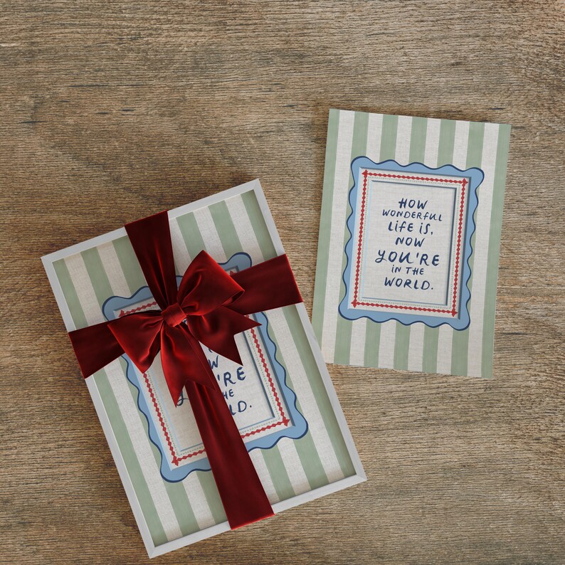 A timeless How Wonderful Life Is Now You’re In the World nursery print in soft sage green tones with classic stripes and a vintage circus feel. Perfect for playroom wall art, kids wall art, and baby room wall decor. This heartfelt nursery quote print adds warmth and meaning to any space, pairing beautifully with sage green nursery art and traditional circus nursery themes. Ideal for parents who love vintage playroom art and storybook-inspired design.