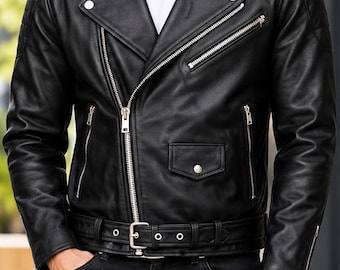 May include: A black leather motorcycle jacket featuring a wide notched collar, silver-tone metal zippers, a front belt with a buckle, and snap button details. The jacket is worn over a plain white t-shirt and paired with dark denim jeans.
