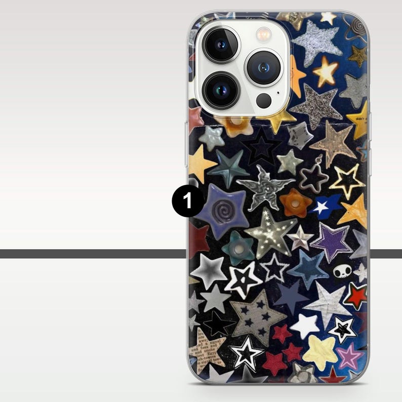 May include: A clear phone case with a dark blue background covered in various colorful star shapes. The stars are in different sizes and colors, including gold, silver, red, and purple. The case has a camera cutout and buttons.