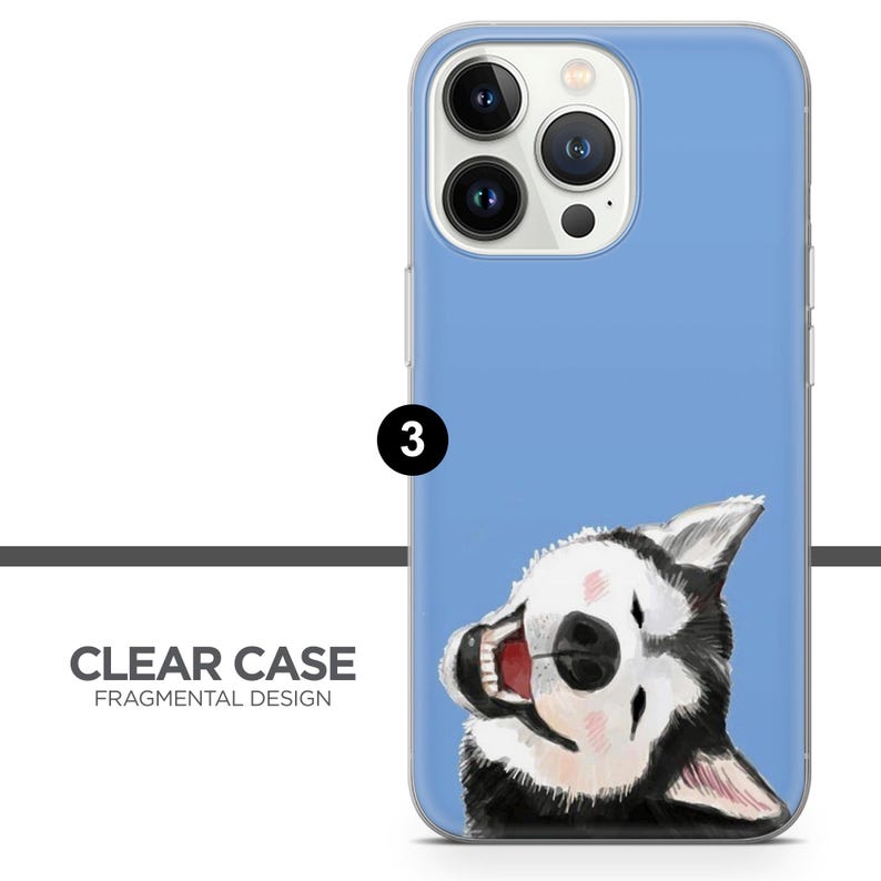 May include: A clear phone case with a blue background and a black and white illustration of a husky dog peeking out from the bottom. The case has a camera cutout for an iPhone 13 Pro.