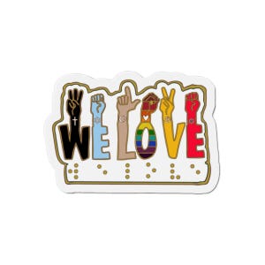 May include: A white sticker with the words "WE LOVE" in black, blue, brown, rainbow, yellow, and red. The letters are formed by hands making various gestures. Braille dots are below the words. The sticker has a gold border.