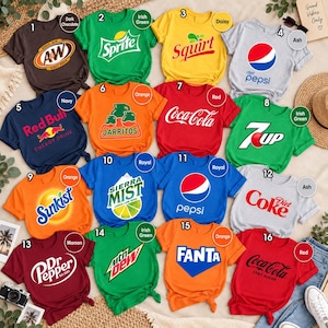 May include: A collection of sixteen short-sleeved t-shirts in various colors, each featuring a different soda or energy drink brand logo, including A&W, Sprite, Squirt, Diet Pepsi, Red Bull, Jarritos, Coca-Cola, 7Up, Sunkist, Sierra Mist, Pepsi, Diet Coke, Dr Pepper, Mountain Dew, Fanta, and Coca-Cola Zero Sugar.