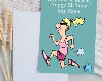 May include: A birthday card with a cartoon illustration of a woman running, wearing pink athletic attire. The card has the text "To A Lover Of Running Happy Birthday Any Name" on a teal background. A white envelope is included.