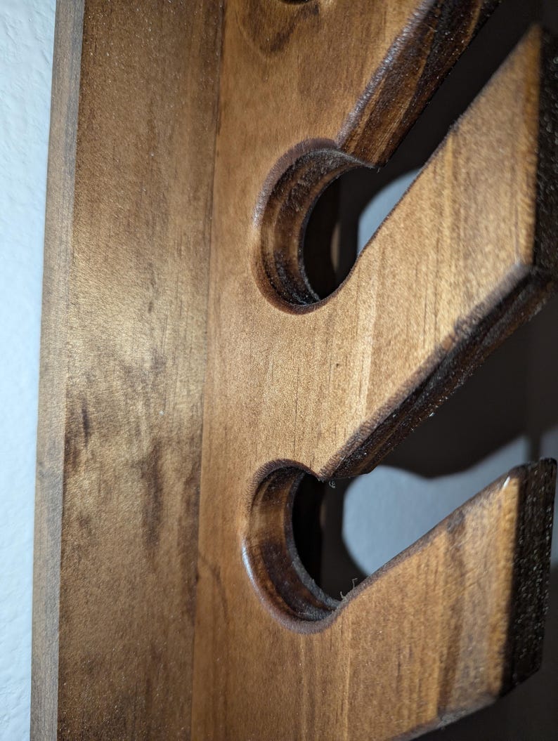 Detail of slot profile with rounded edges on the wooden hat rack.